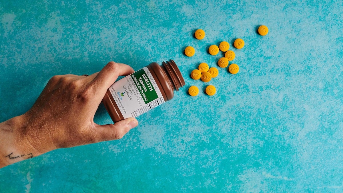 pouring pills on blue background